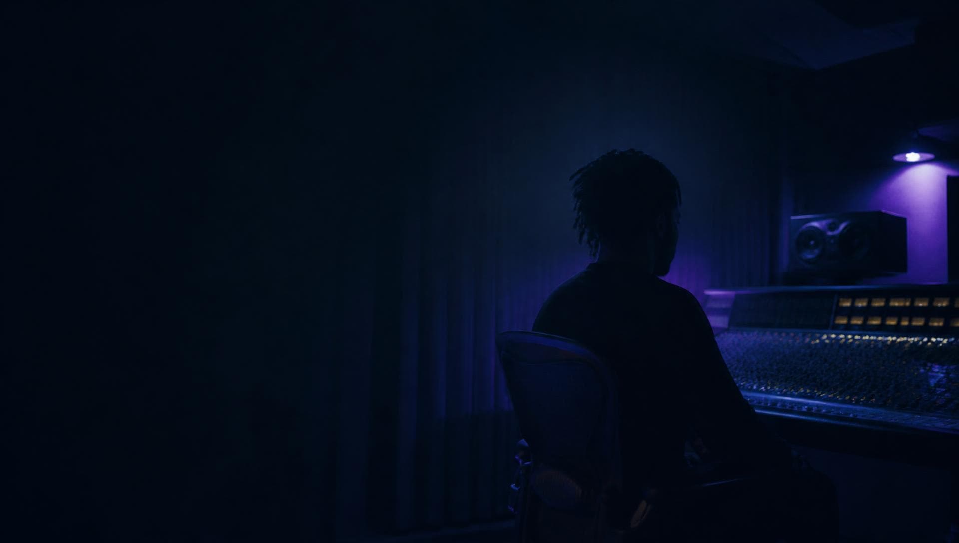 Artist working at a studio mixing desk