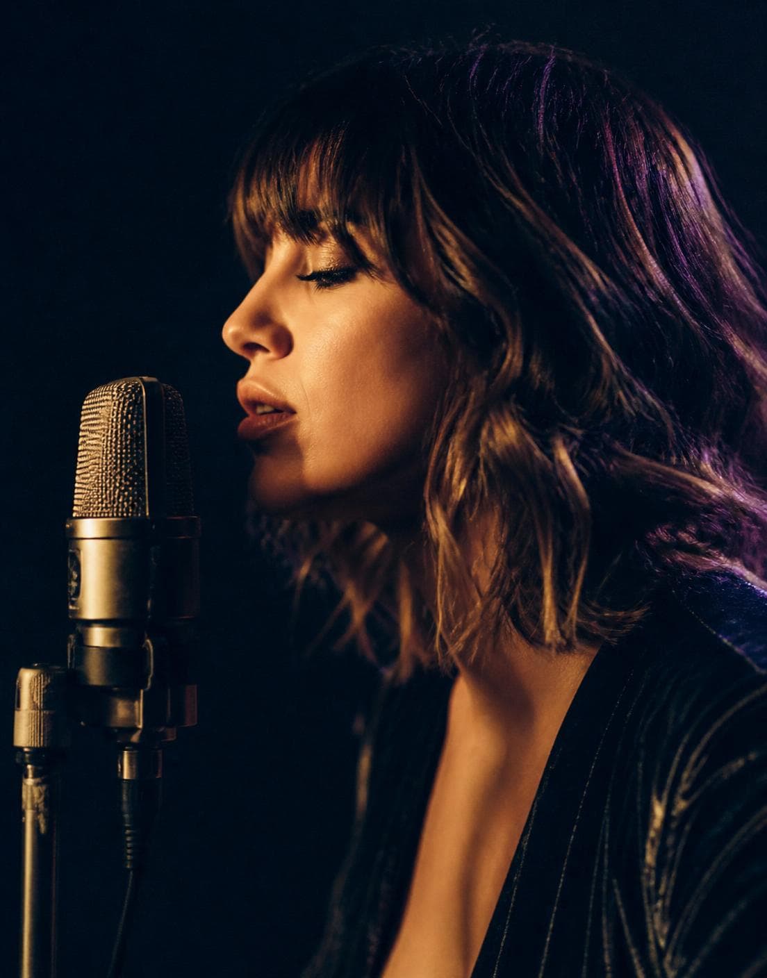 Singer recording at a studio microphone